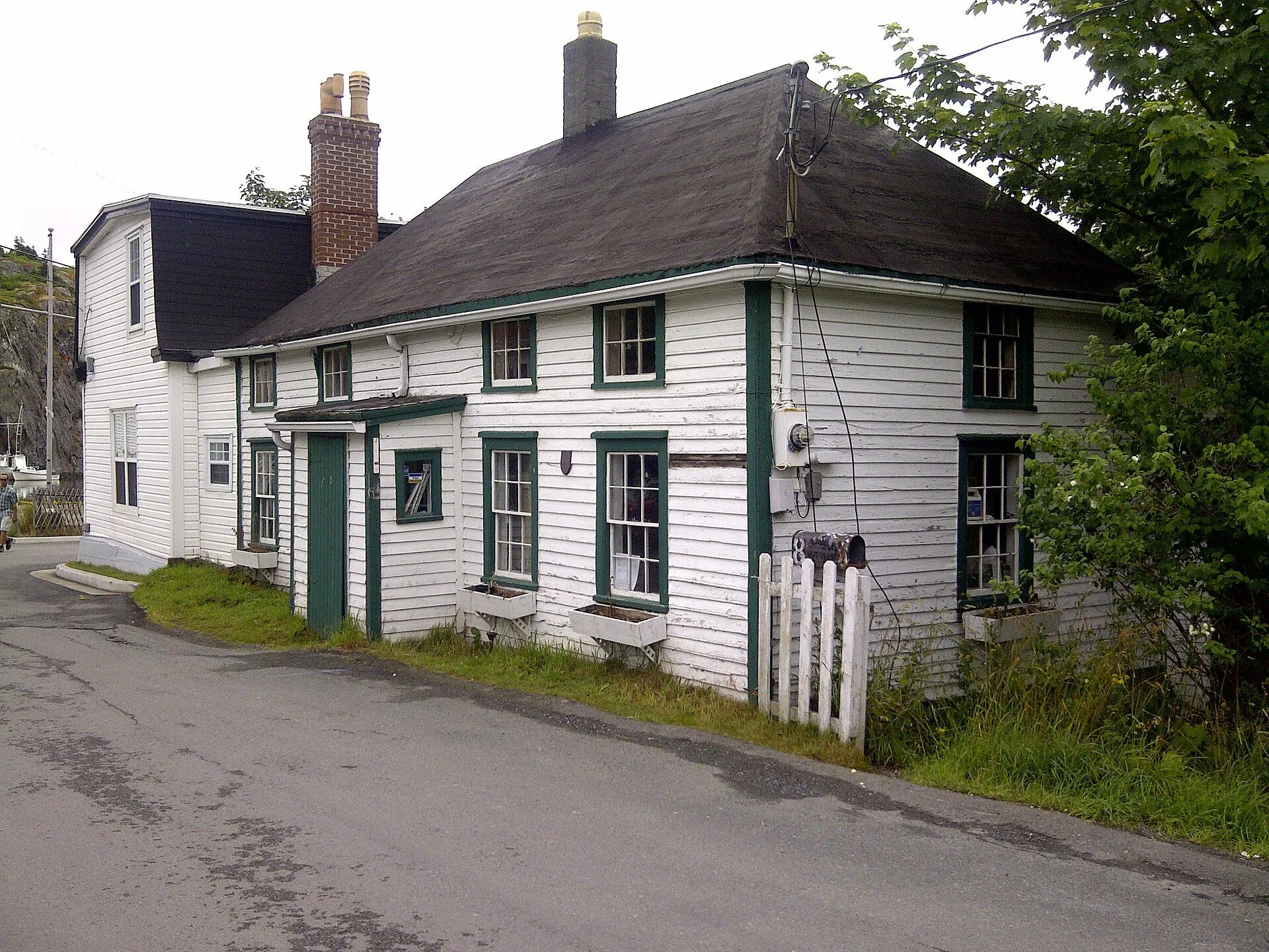Mallard Cottage, a white clapboard house with green trim from around 1820, on a lane in Quidi Vidi Village.