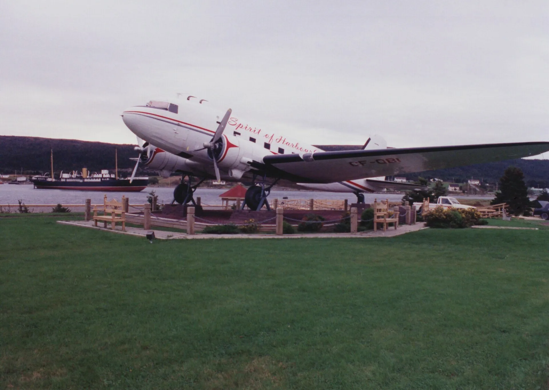 The DC-3 aircraft Spirit of Harbour Grace on display on a grassy lawn by the harbour at Harbour Grace.