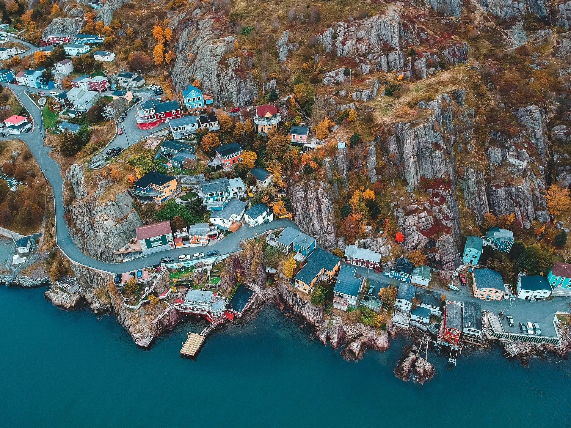 An aerial view of The Battery's houses and winding lane clinging to the cliffs above the Narrows in St. John's.